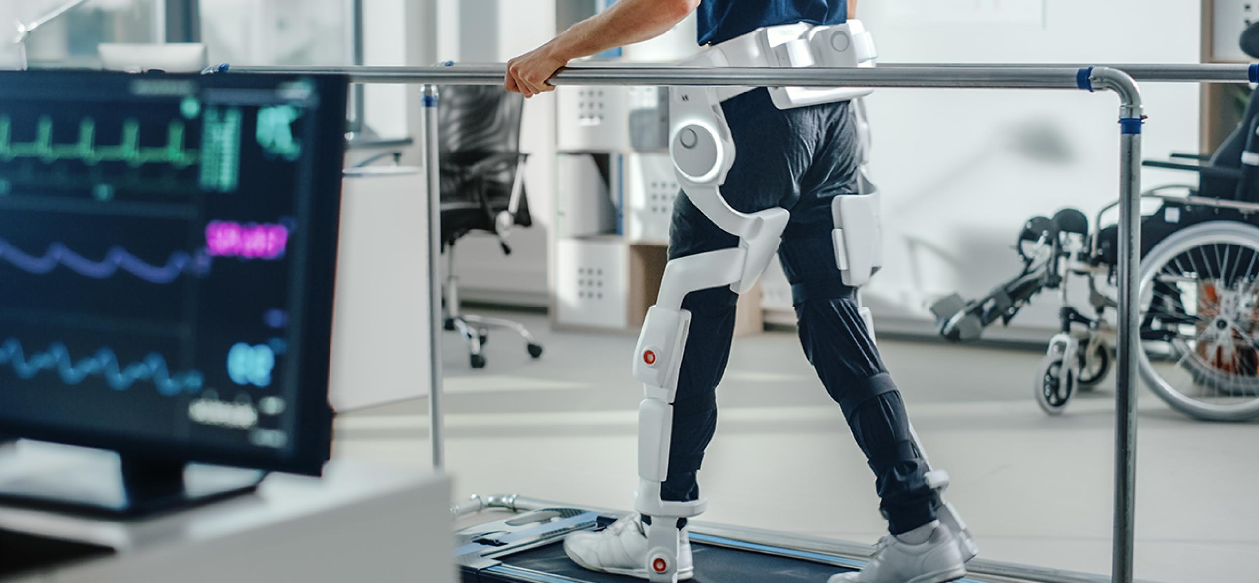 Person walking on treadmill with exterior prosthetics